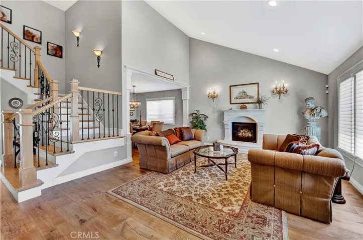 Elegant Formal Living Room with Soaring Ceiling, Sconce and Recessed Lighting