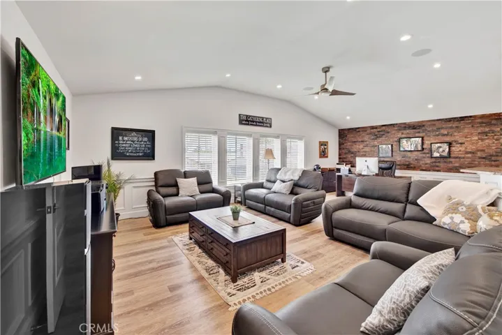 Giant Bonus Room has Cathedral Ceiling, Recessed Lighting, Ceiling Fan, Wood Vinyl Flooring, Crown Molding, and a Beautiful Entertainer's Wet Bar