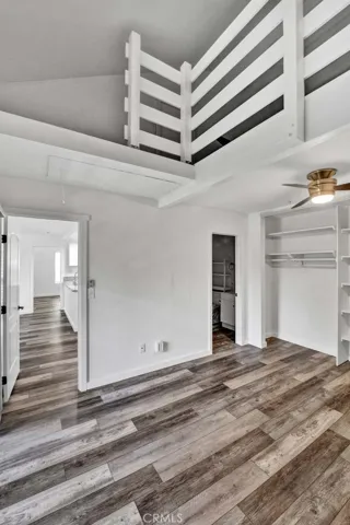 View of storage loft in second bedroom with pull-down stairs.