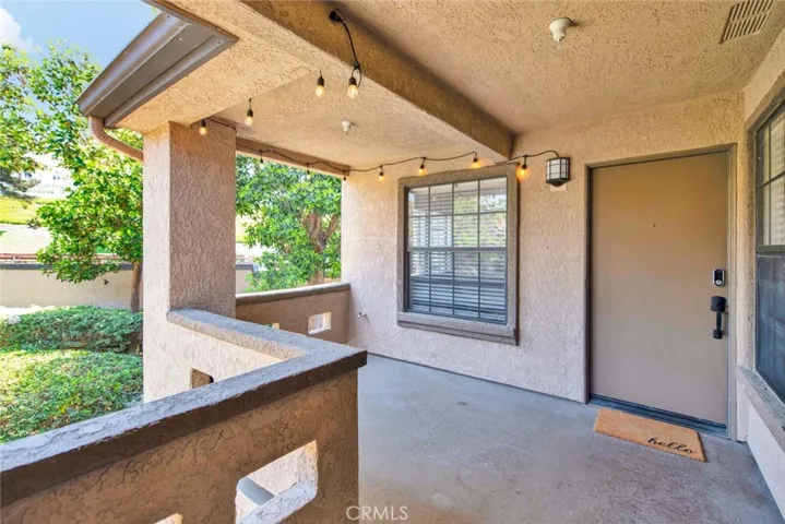 Spacious private balcony with view of the lush landscaping, running streams and hills views.  Bistro lights included.