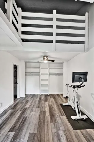 Another view of second bedroom with storage loft and wall to wall closet.