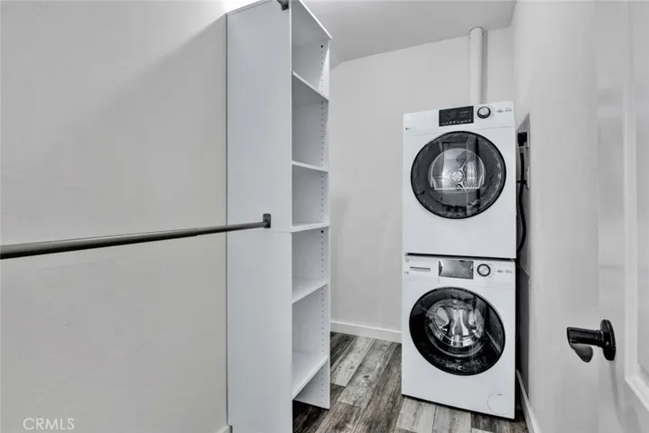 Walk-in closet with stackable washer and dryer.