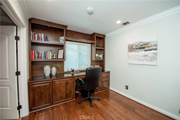 Second floor landing has custom built desk/cabinets.
