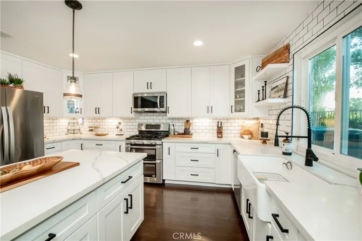Custom ceiling level white shaker kitchen cabinets.