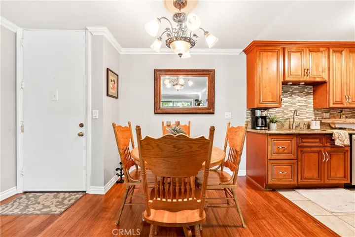Beautiful upgraded kitchen with granite counters, custom cabinetry and backsplash.