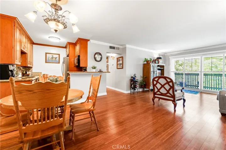 Lovely living room with bamboo flooring, crown molding, HVAC.  Open concept and full access to your private balcony.