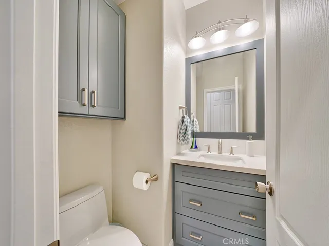 The downstairs half bathroom is remodeled with a beautiful Quartz vanity, light fixtures and more.