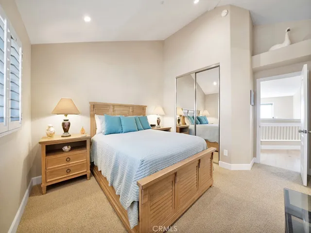 Another view of the guest bedroom showing the mirrored walk in closet.