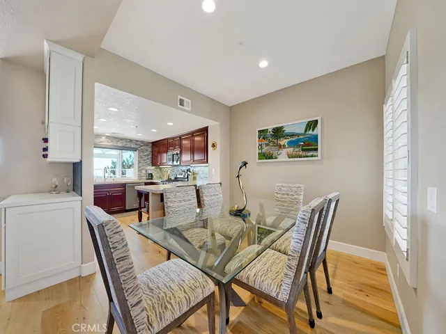 The dining room is adjacent to the kitchen. There is also a bartop seating area.