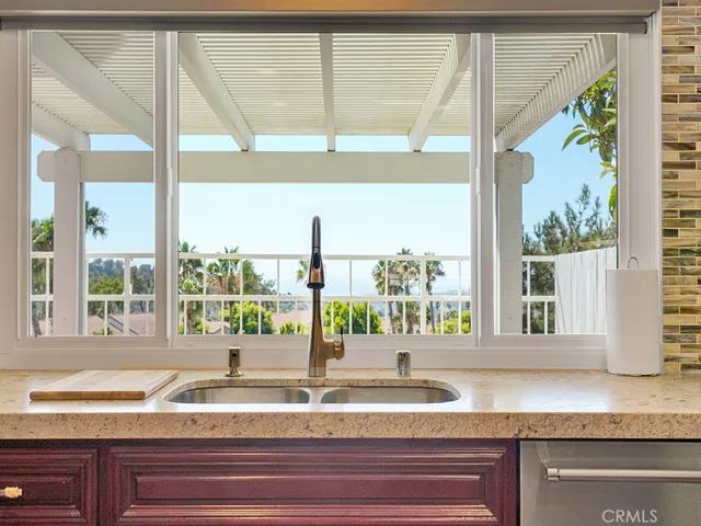 Doing the dishes is an enjoyable activity when you have unobstructed panoramic ocean and Catalina Island views from your gorgeous kitchen.