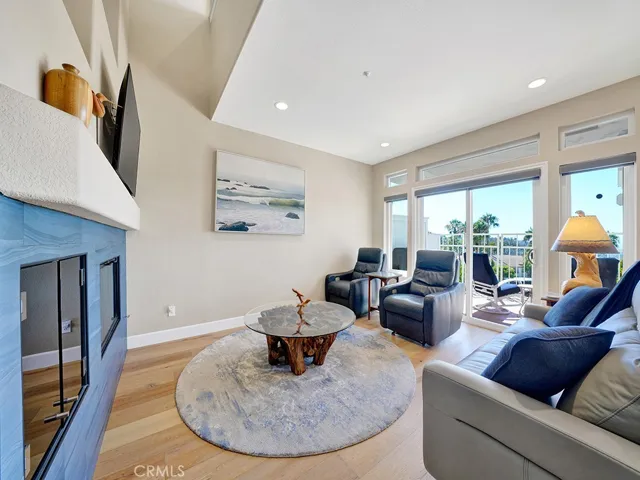 The living room has engineered hardwood floors, a remodeled fireplace and dual pane windows and sliding glass door.