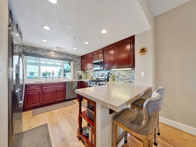 The kitchen has been fully remodeled with leathered granite countertops, custom cabinets, designer tile backsplash and more.
