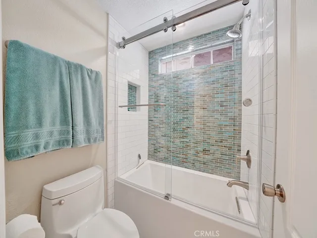 The ensuite guest bedroom's shower features high end tile to make a showcase impression.