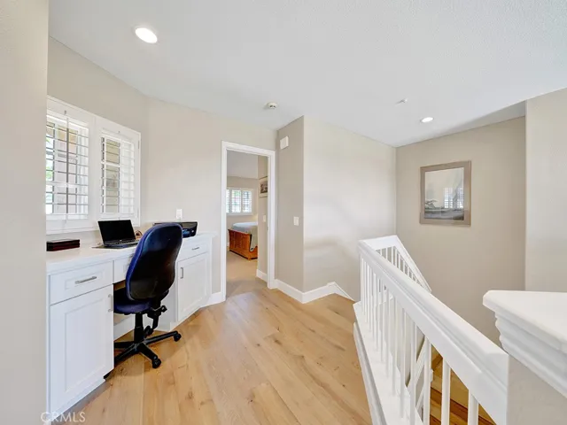 The hallway landing area upstairs features engineered hardwood floors.