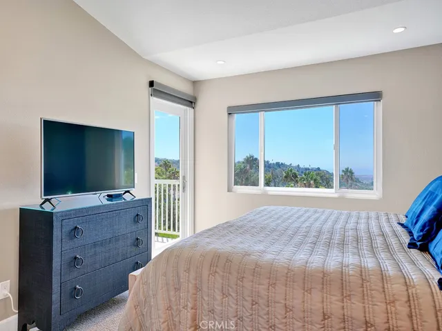 The primary bedroom has direct access to the balcony to savor in the views.