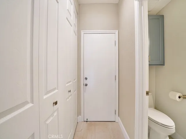 Direct access garage with a closeted washer and dryer area.