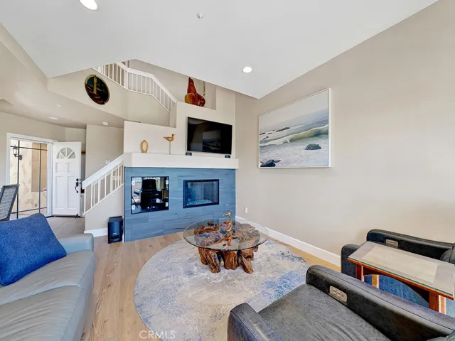The living room fireplace has been remodeled with designer tile and a fire and ice fireplace.