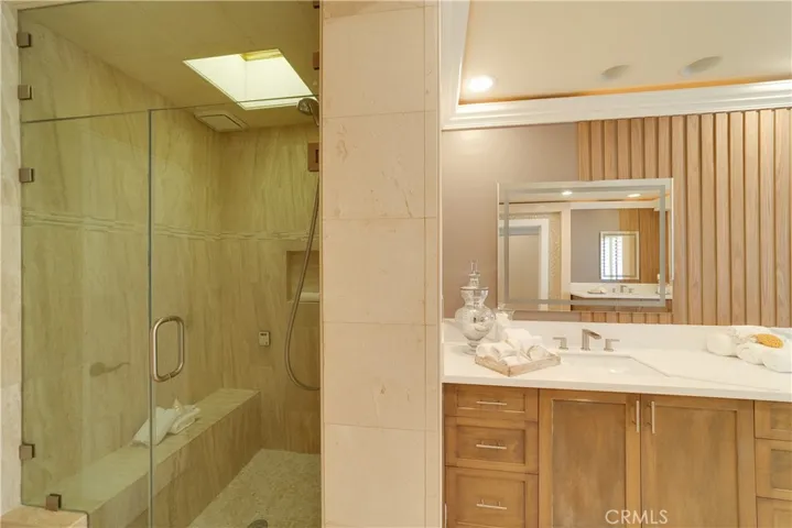 A shower/steam room with heat lamps in the primary bath.