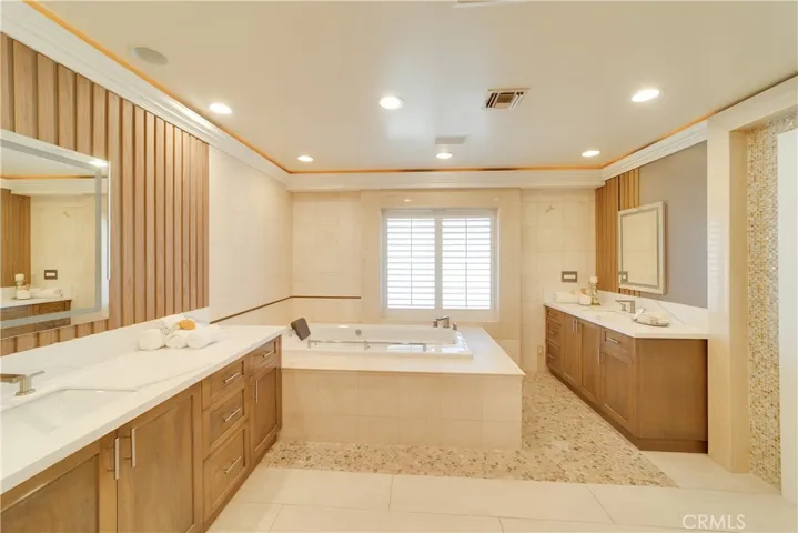 Dual vanities and cove lights in the master bath.