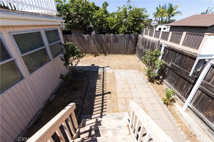 Backyard and stairs that lead up to the rooftop deck