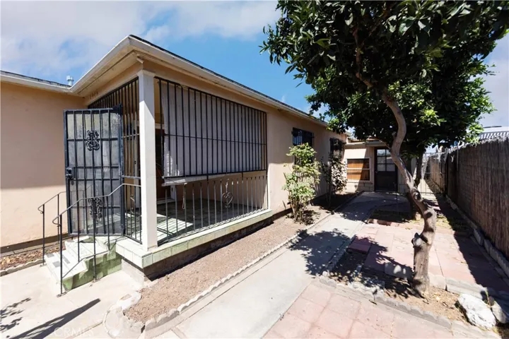 Entrance into the house. Also showing side yard. The building you see in the back is the garage.