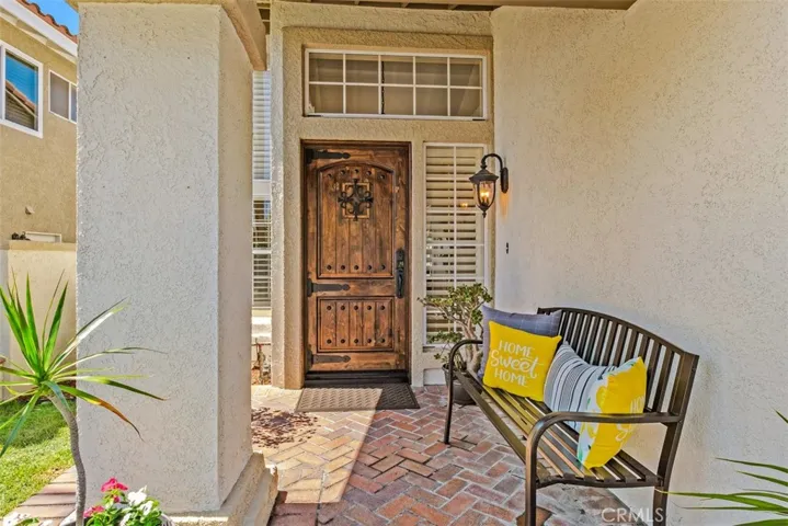 Step through this welcoming front porch complete with a custom designed door.
