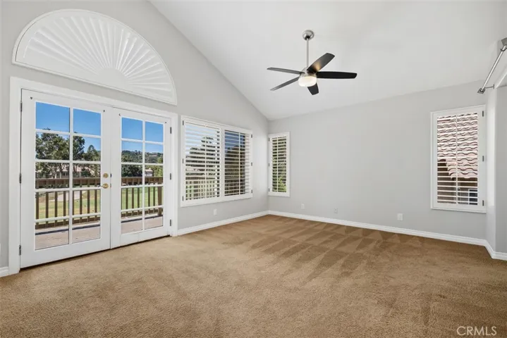 The primary bedroom features a light and airy space with a outdoor balcony overlooking the fairway and hillside views.