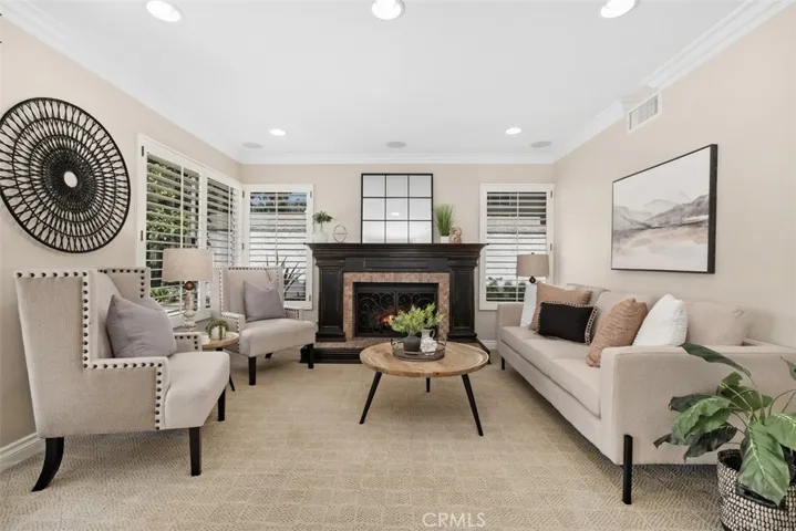The family room features a welcoming fireplace, direct access to the outdoor living area, kitchen and a hallway leading to the main floor bedroom, bath, laundry room and 3 car garage..