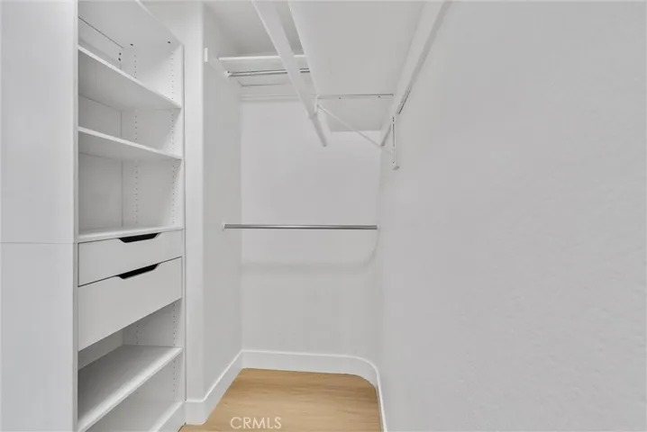 Primary bedroom walk in closet