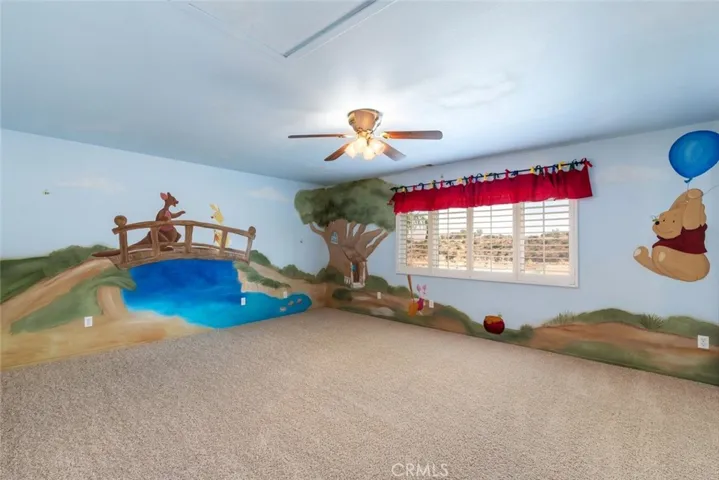 The children's bedroom is transformed into a wonderland with playful murals and vibrant decor.