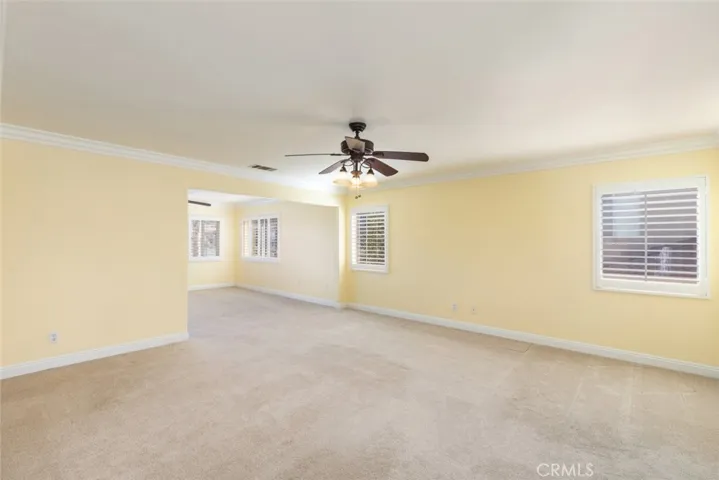 The expansive primary bedroom offers an open layout with ample space for a sitting area.