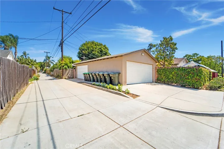 TWO separate 2-car garages and alley access