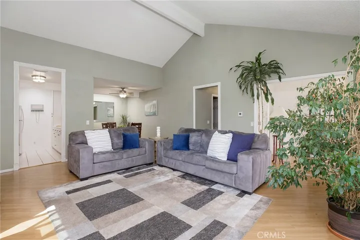 Great room with natural light, opens to kitchen and dining room.