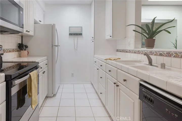 Kitchen that opens to great room and dining room with skylight