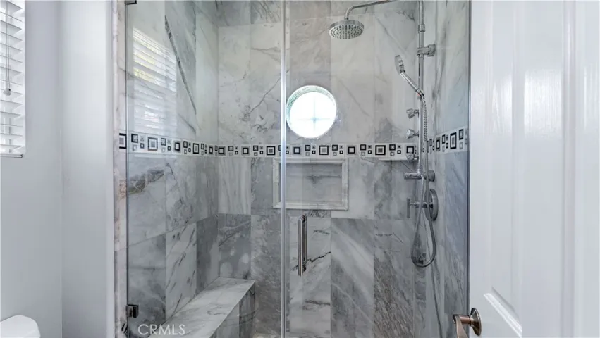Modern touches complete the shower in the hall bath.