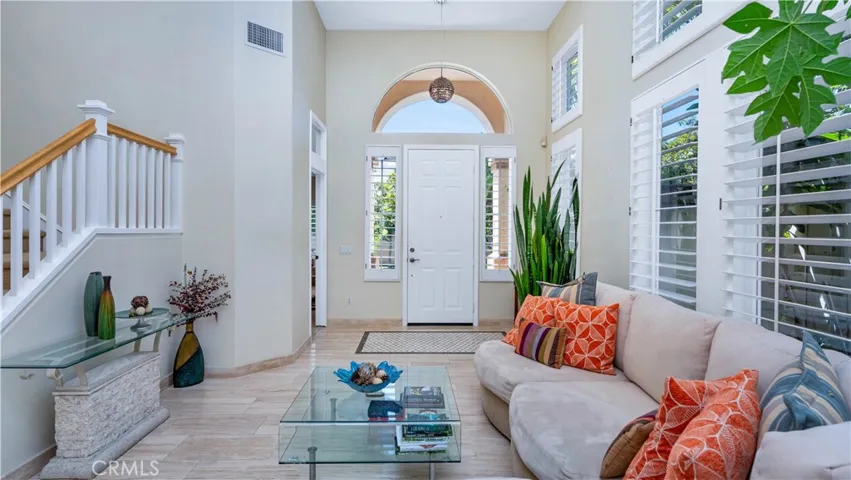 Foyer and whole first floor has Designer Travertine tile and cathedral ceilings.
