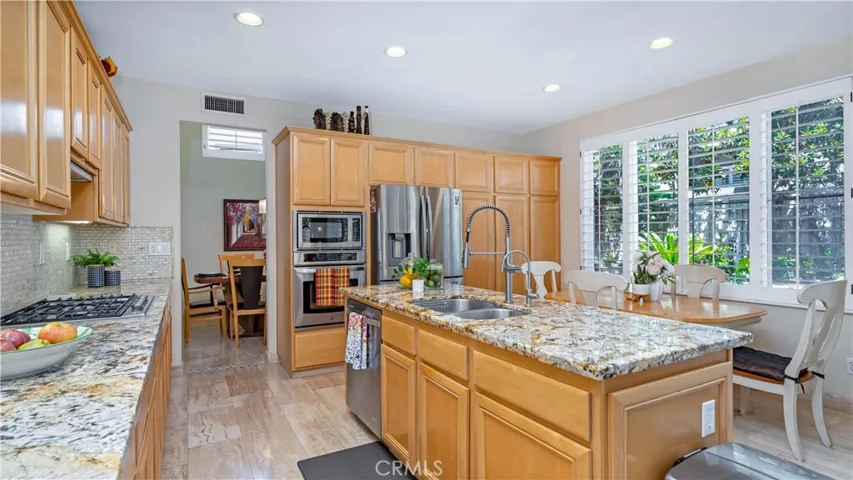 Stainless steel appliances and built-in range.