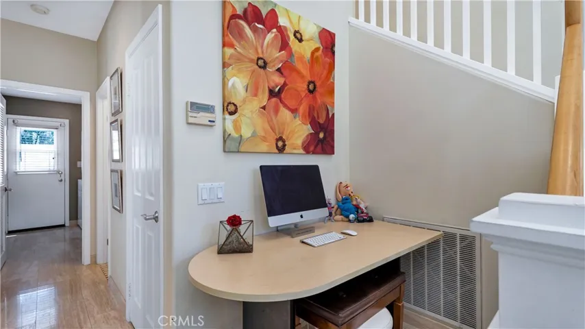 Tucked away by the stairs, a 2nd work area.