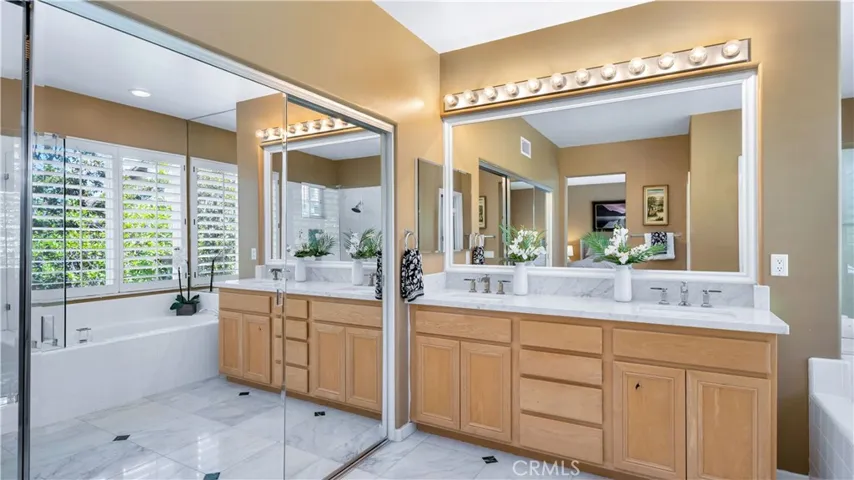 Primary suite bath has spa like qualities, with dual sinks, oval tub and ...