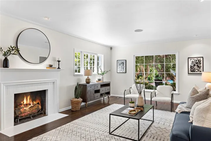 Formal living room with firepace, built-ins and rear yard picture window