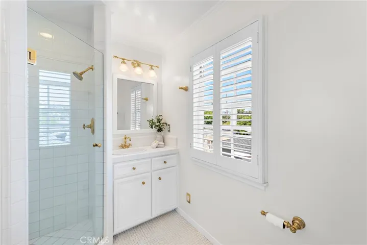 Master bath with tile floors, plantation shutters and updates shower