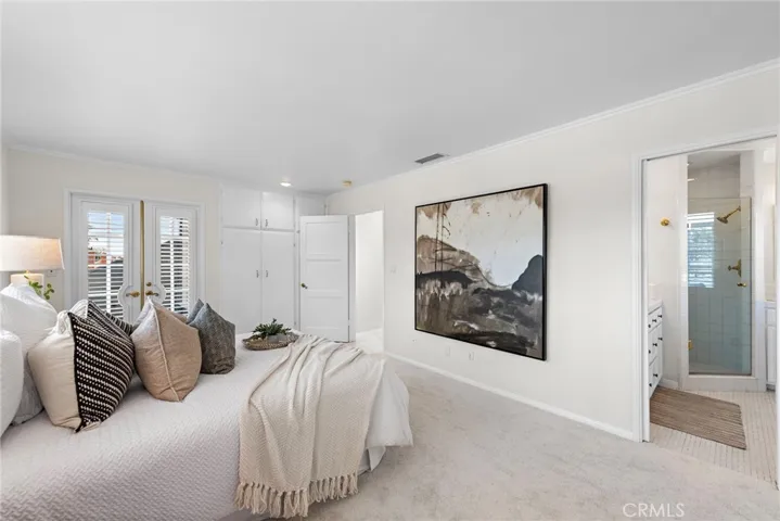 Master suite w/ built in bench seat, wall of front windows & french doors to outside balcony