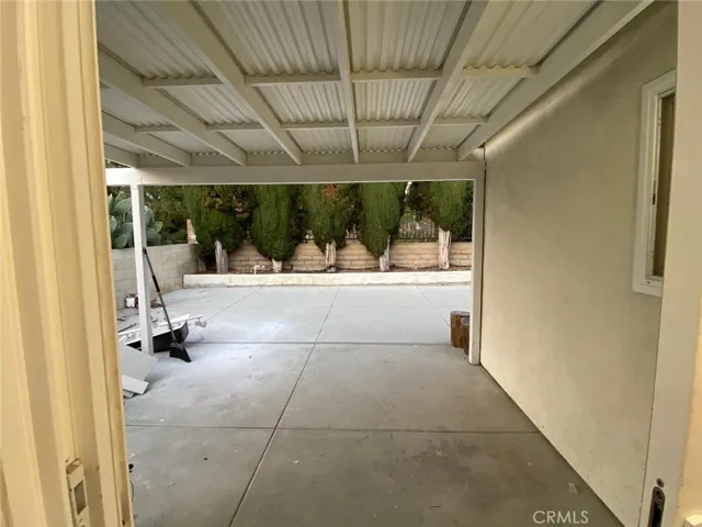 covered patio off the kitchen that opens up to the backyard.