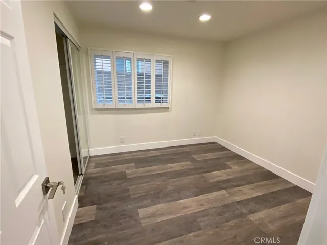 Bedroom# one with recessed lights, Plantation shutters and mirror closet doors.
