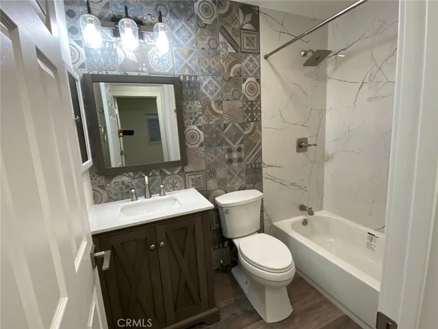 Guest bathroom remodeled completely with designer tiles and quartz. Brand new toilet and vanity and bath tub and light fixtures.