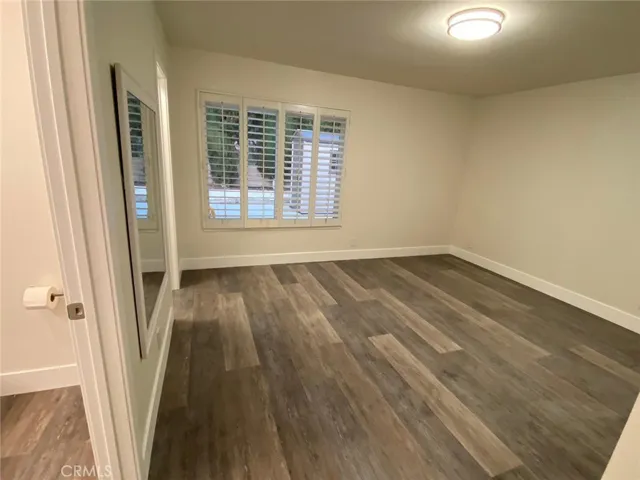 Mater bedroom with plantation shutters and LED light fixture and plantation shutters.