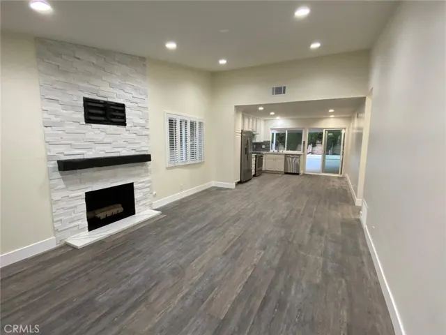 Beautiful Fire place with the custom mantel and stack stone and TV mount off the living room.