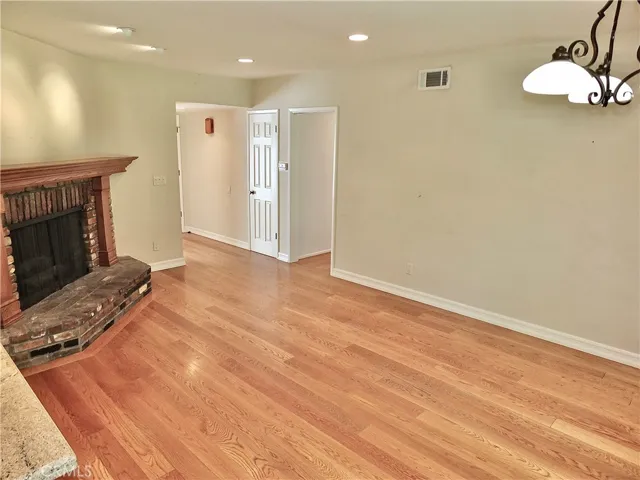 family/dining room overlooking the warm romantic brick gas fireplace