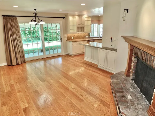 family/dining room overlooking the warm romantic brick gas fireplace