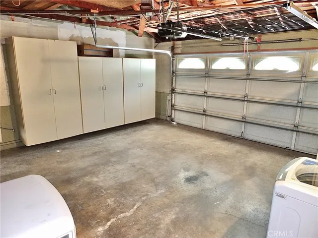 attached two car garage with direct house access, ample storage, and a washer/dryer